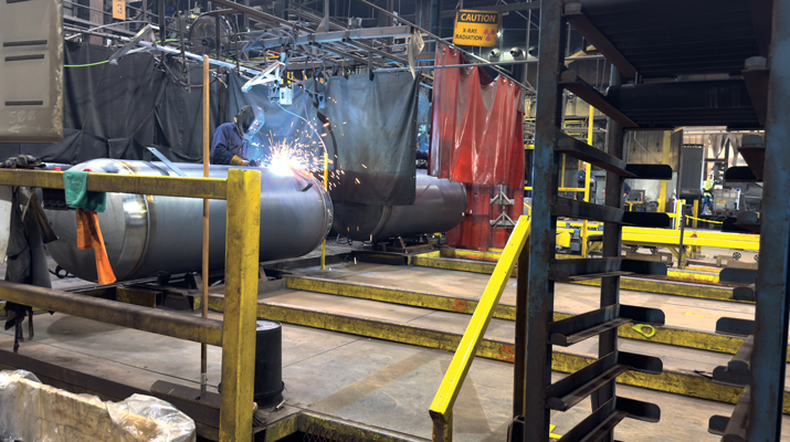 A Quality Steel employee welds a propane tank in its manufacturing facility. (Photo by Shirnae Richardson)