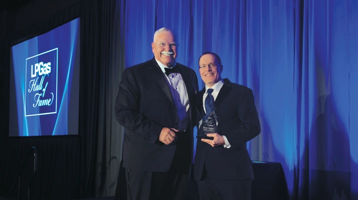 Inductee Denis Gagne of Eastern Propane & Oil, left, joins Richesson on stage. (Photo by LP Gas Staff)